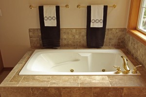 Tub with porcelain tile and brass faucet