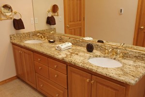 Vanity with Granite countertops and brass faucets